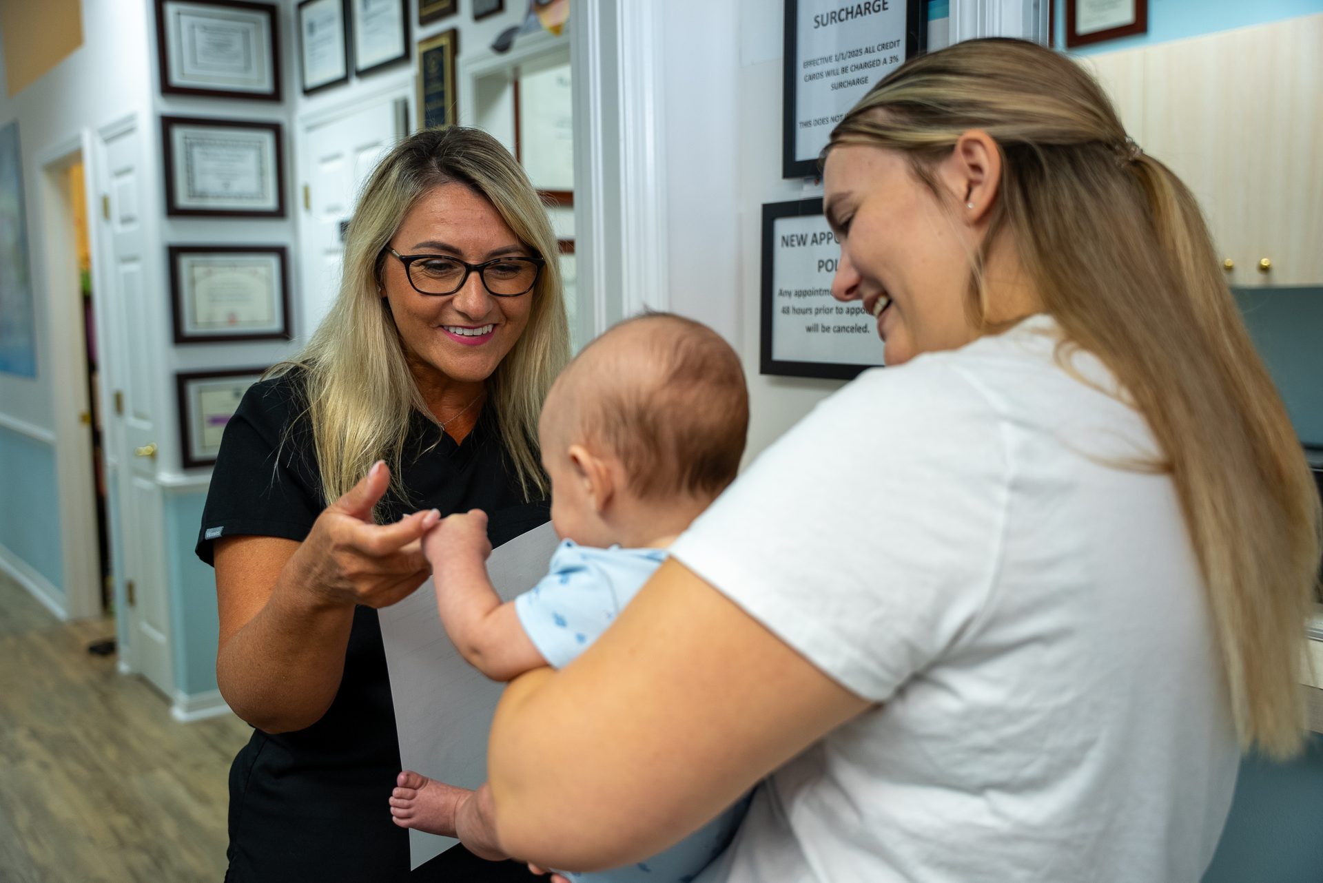 Cool Kid Dental team member warmly welcoming a mom and her baby in North Port